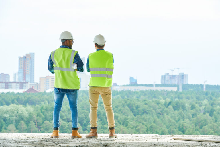 Anonymous construction engineers looking at city